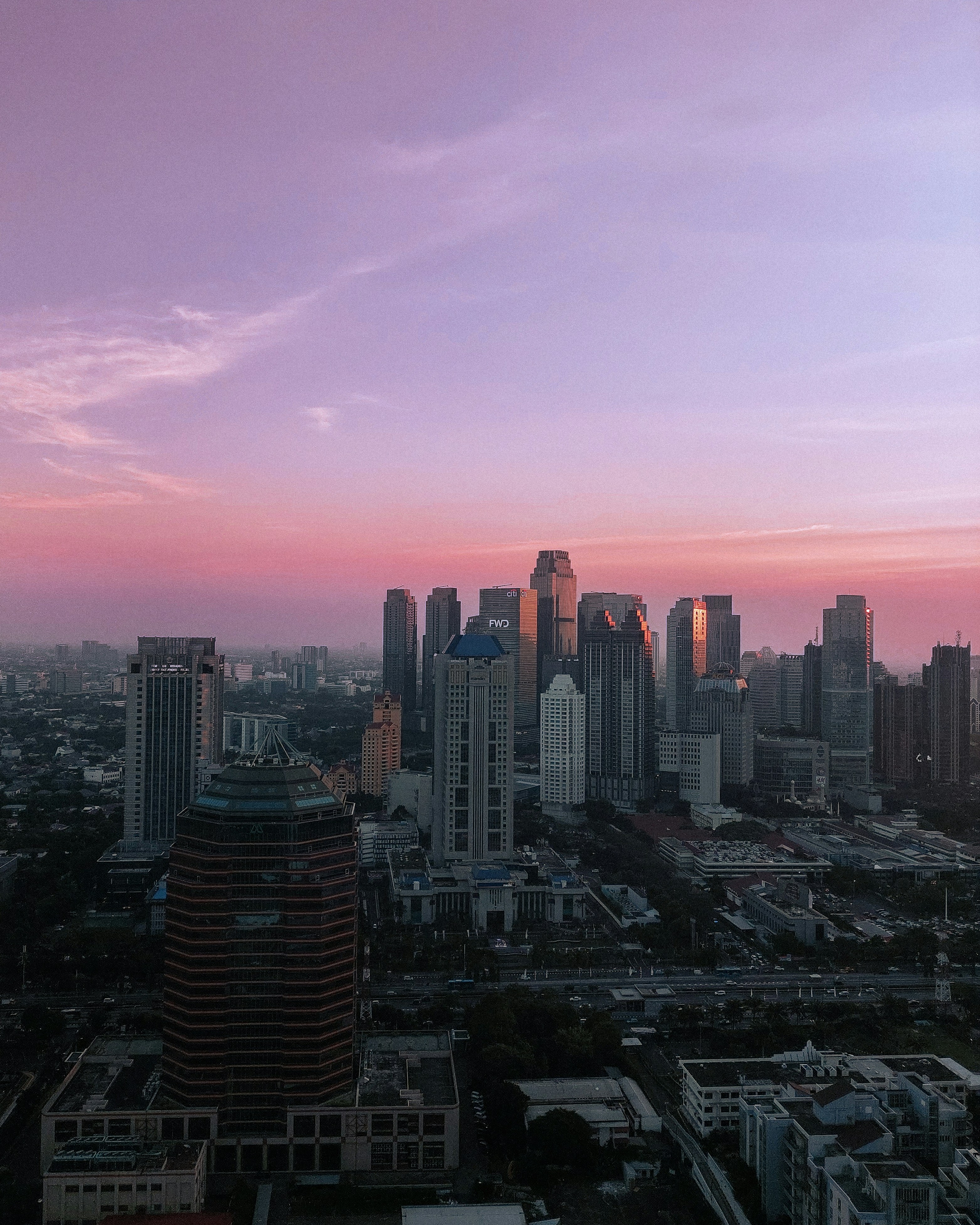 a view of a city at sunset from the top of a building